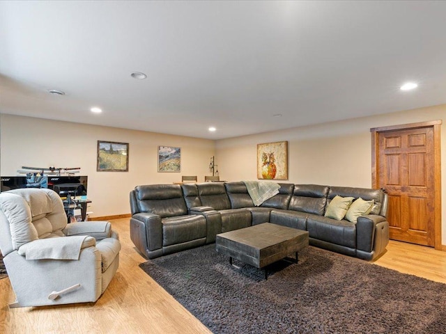 living area featuring recessed lighting, baseboards, and light wood finished floors