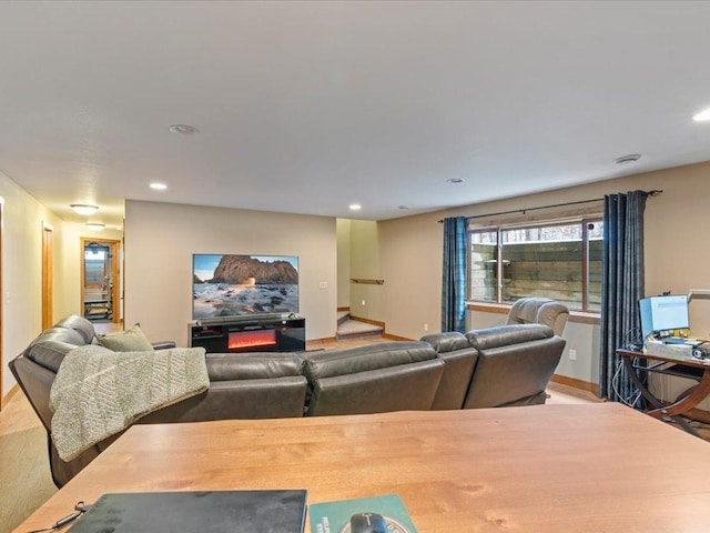 living area with recessed lighting, baseboards, a lit fireplace, and wood finished floors