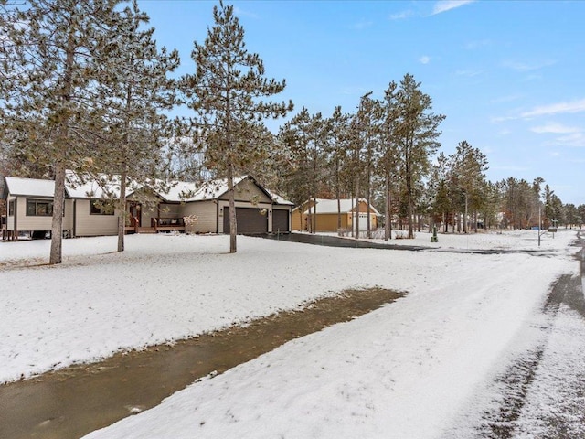 yard layered in snow featuring a garage