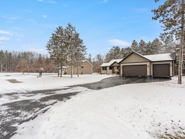 snowy yard with an attached garage