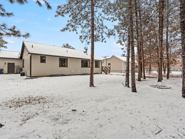 snow covered house with a detached garage