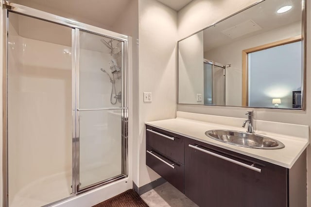 bathroom featuring a stall shower and vanity