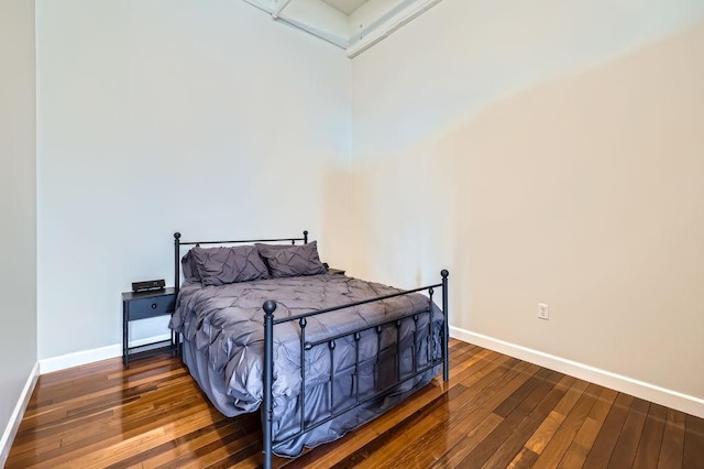 bedroom with baseboards and hardwood / wood-style floors