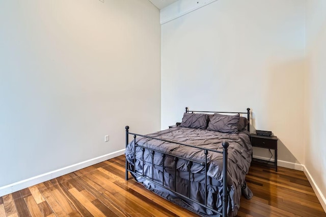 bedroom featuring hardwood / wood-style flooring and baseboards