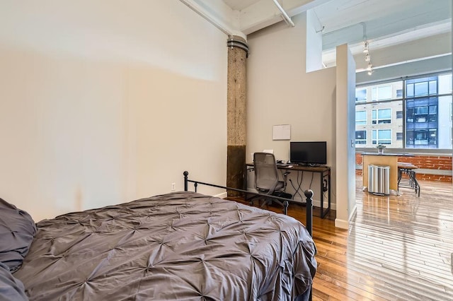 bedroom with baseboards and hardwood / wood-style floors