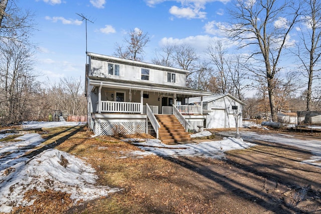 view of front facade with driveway, stairway, an outbuilding, covered porch, and a trampoline