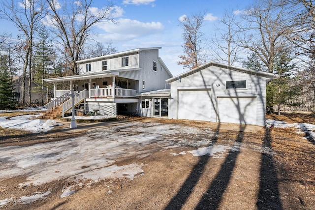 view of front of house featuring driveway and a porch