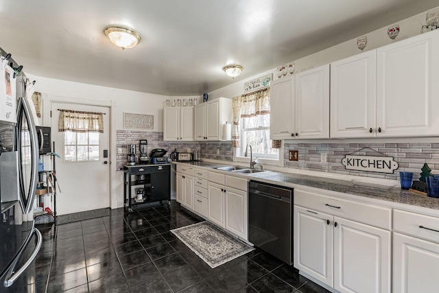 kitchen featuring white cabinets, dishwasher, and a sink