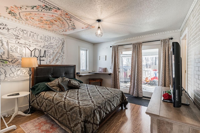 bedroom featuring a textured ceiling, multiple windows, wood finished floors, and crown molding