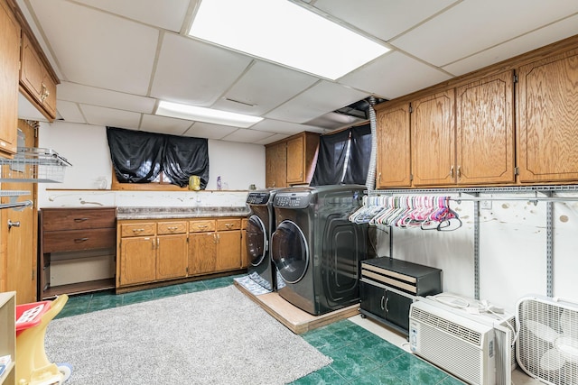 laundry room with cabinet space, dark floors, a wall mounted air conditioner, and independent washer and dryer