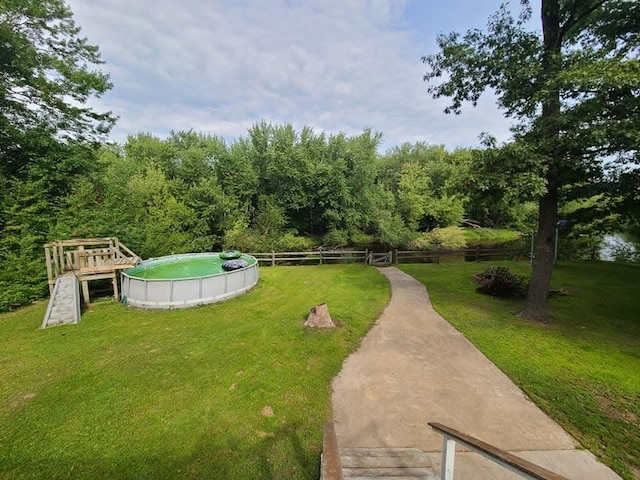 view of yard with fence and a fenced in pool