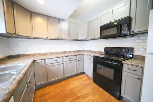 690 Western Ave N, Saint Paul, MN 55103 - kitchen with black appliances, backsplash, gray cabinetry, and light wood-style floors