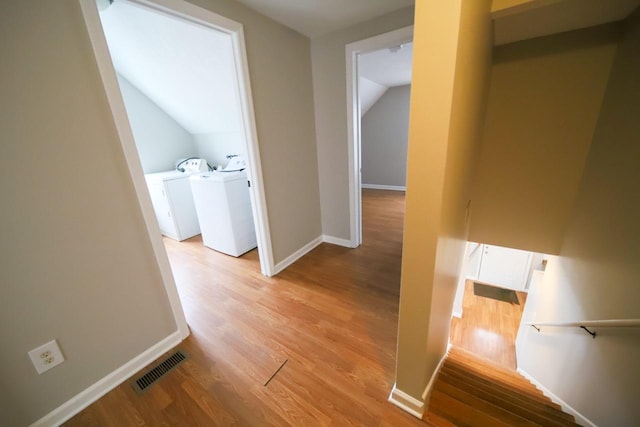 690 Western Ave N, Saint Paul, MN 55103 - hallway with washer and dryer, light wood-style floors, and vaulted ceiling