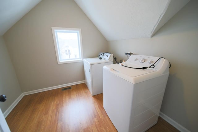 690 Western Ave N, Saint Paul, MN 55103 - laundry area featuring washer and clothes dryer and light wood-style flooring