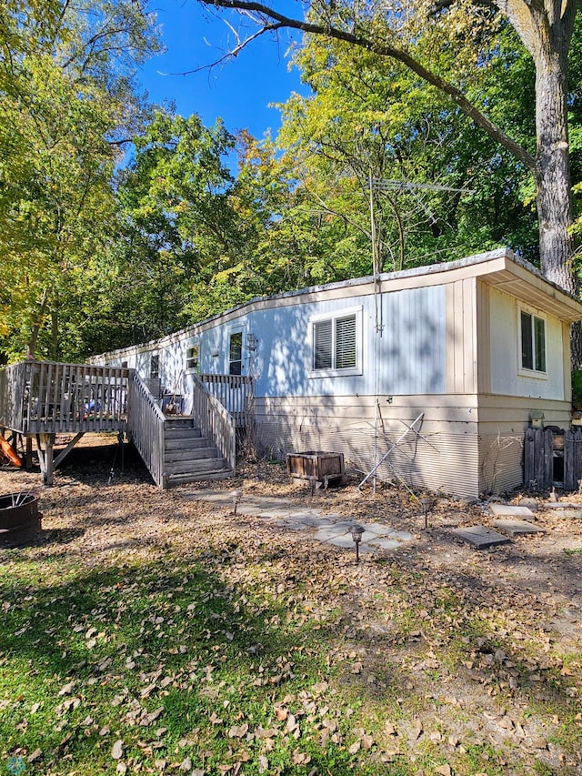 view of side of home with a wooden deck