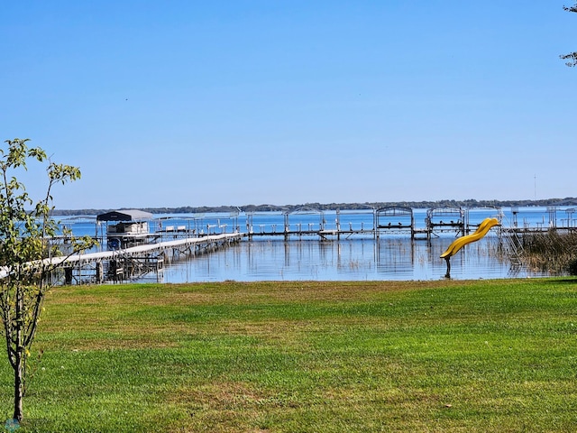 view of dock featuring a yard and a water view