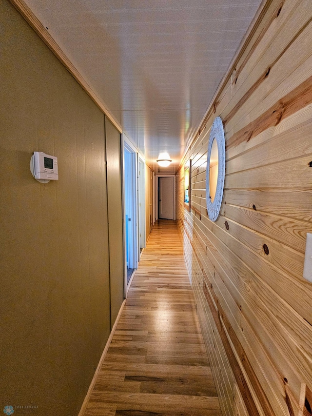 hall featuring wooden walls and wood finished floors