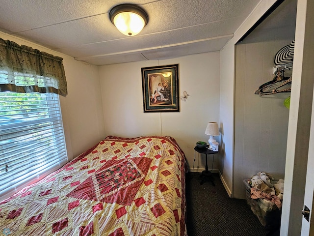 carpeted bedroom with a textured ceiling