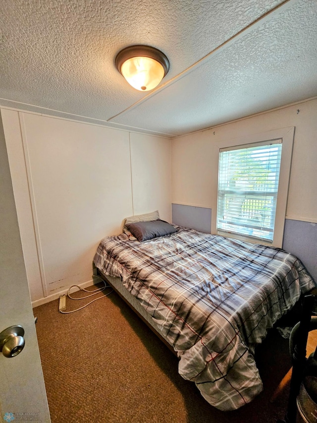 carpeted bedroom with a textured ceiling