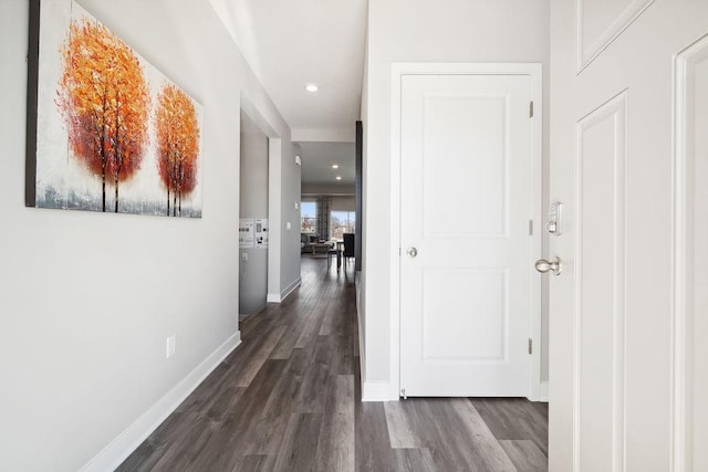 hallway featuring baseboards, dark wood-type flooring, and recessed lighting