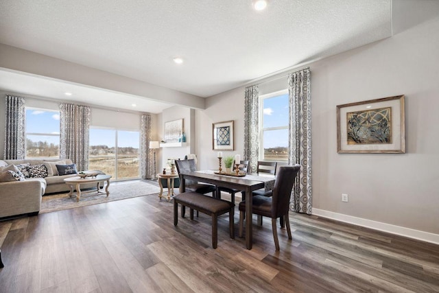 dining room featuring dark wood-style floors, recessed lighting, a textured ceiling, and baseboards