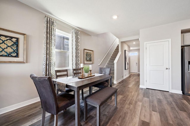 dining space with stairs, dark wood-style flooring, recessed lighting, and baseboards