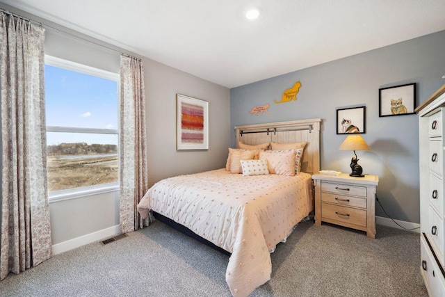 bedroom with light colored carpet, visible vents, and baseboards