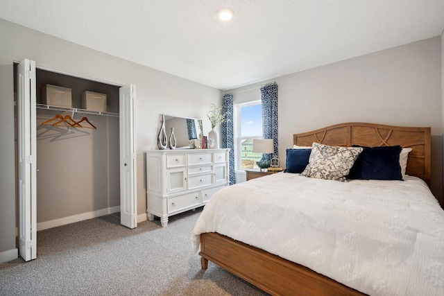 bedroom with a closet, baseboards, and carpet flooring