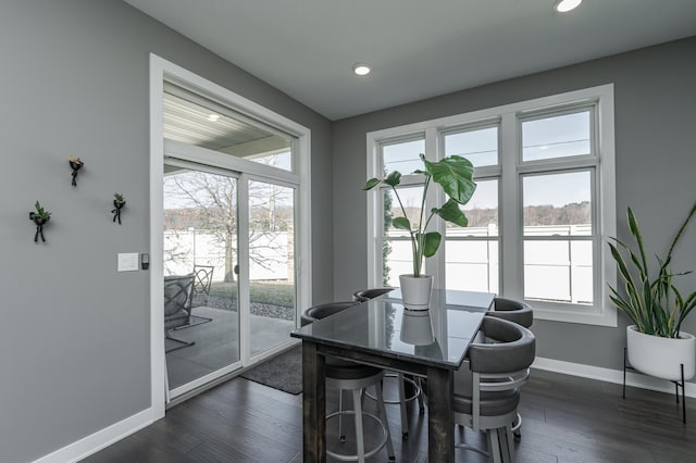 dining area featuring baseboards, dark wood finished floors, and recessed lighting