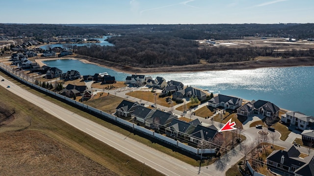 birds eye view of property with a water view and a residential view