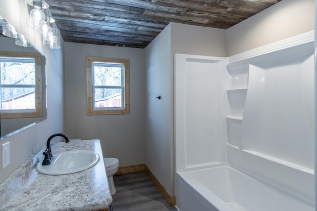 9806 County Road 144, Brainerd, MN 56401 - bathroom featuring vanity, toilet, wood ceiling, wood finished floors, and baseboards