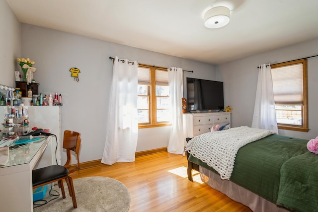 bedroom featuring light wood-style flooring and baseboards