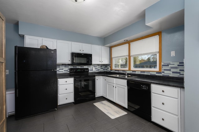 kitchen featuring dark countertops, black appliances, white cabinetry, and a sink