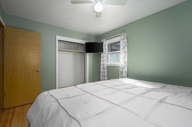 bedroom with a closet, ceiling fan, and wood finished floors