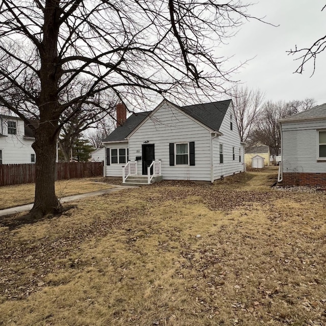 view of front of property featuring fence and a chimney