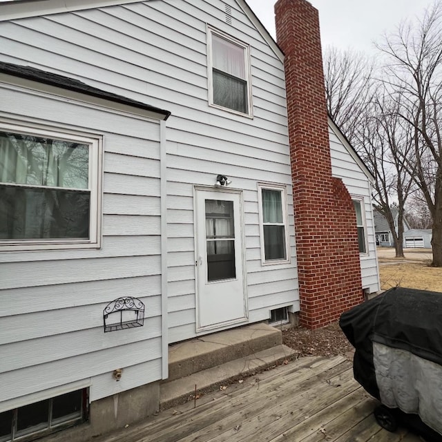 exterior space featuring a deck and a chimney