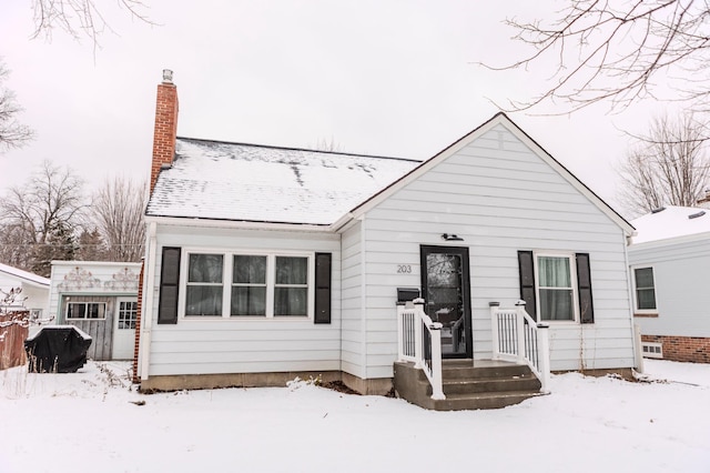 view of front of house featuring a chimney