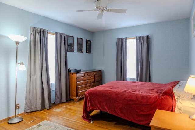 bedroom with ceiling fan and light wood finished floors