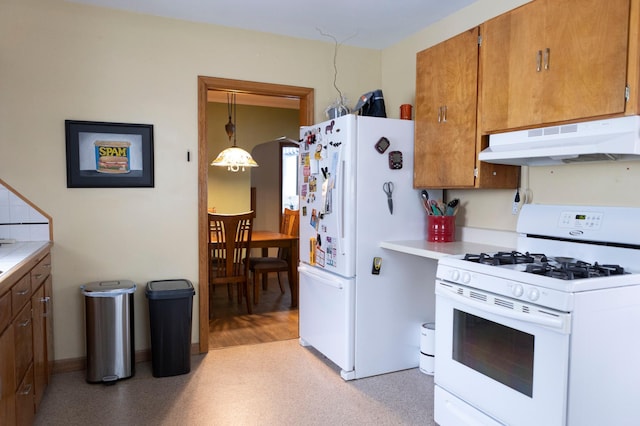 kitchen featuring brown cabinets, under cabinet range hood, tile countertops, and white appliances