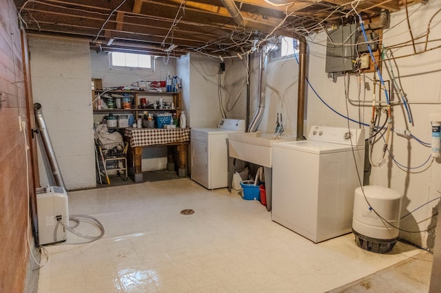 basement featuring a sink, washer and dryer, and tile patterned floors