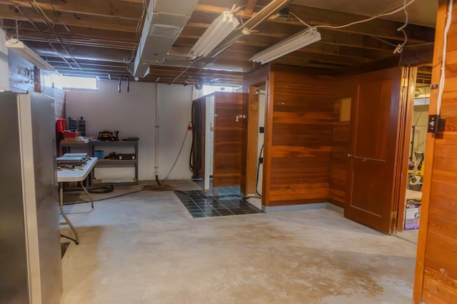 basement featuring freestanding refrigerator