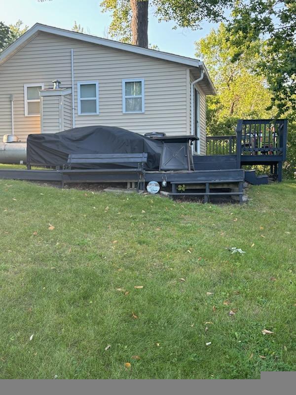 back of house with a yard and a wooden deck