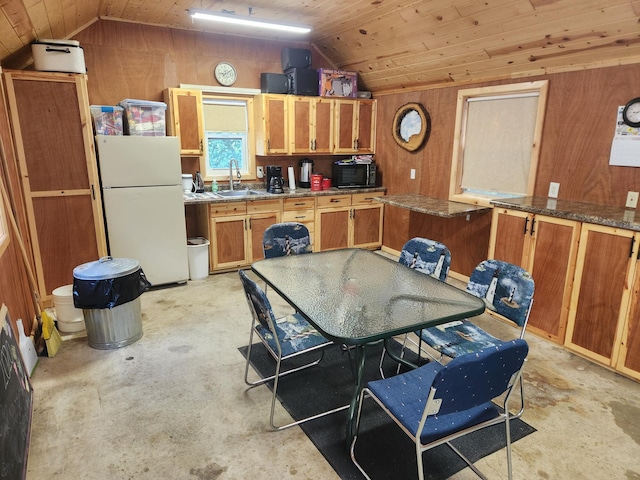 kitchen with wooden ceiling, vaulted ceiling, a sink, and freestanding refrigerator