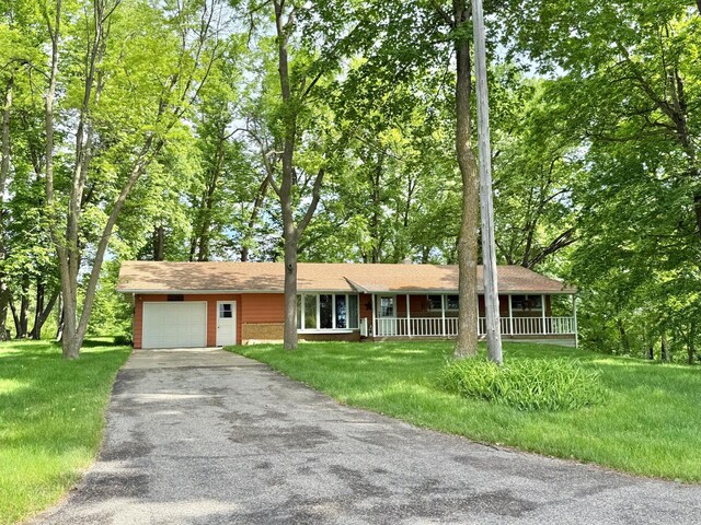 34257 Dusty Trl, Frazee, MN 56544 - ranch-style home with asphalt driveway, a garage, covered porch, and a front yard