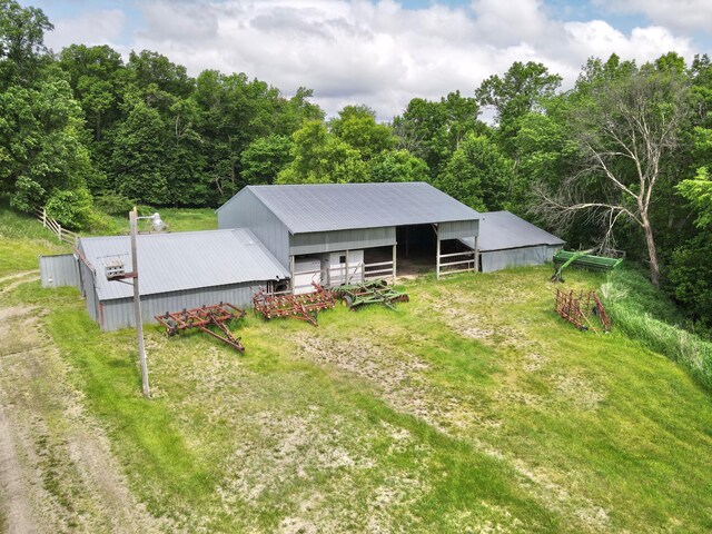 34257 Dusty Trl, Frazee, MN 56544 - view of front of property with an outbuilding, an outdoor structure, metal roof, and a forest view