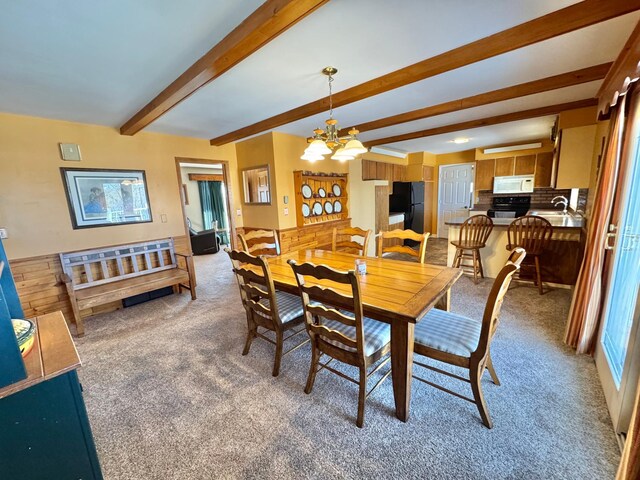34257 Dusty Trl, Frazee, MN 56544 - dining space featuring light carpet, a chandelier, and beam ceiling