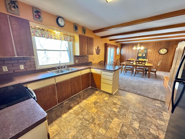 34257 Dusty Trl, Frazee, MN 56544 - kitchen featuring a sink, decorative backsplash, plenty of natural light, a peninsula, and beamed ceiling