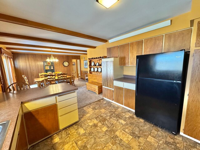 34257 Dusty Trl, Frazee, MN 56544 - kitchen featuring freestanding refrigerator, wood walls, stone finish flooring, beam ceiling, and dark countertops
