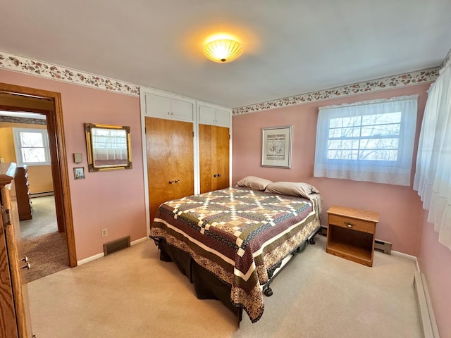 34257 Dusty Trl, Frazee, MN 56544 - bedroom featuring light carpet, two closets, baseboard heating, and baseboards