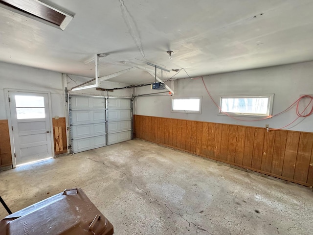34257 Dusty Trl, Frazee, MN 56544 - garage featuring a garage door opener and wooden walls